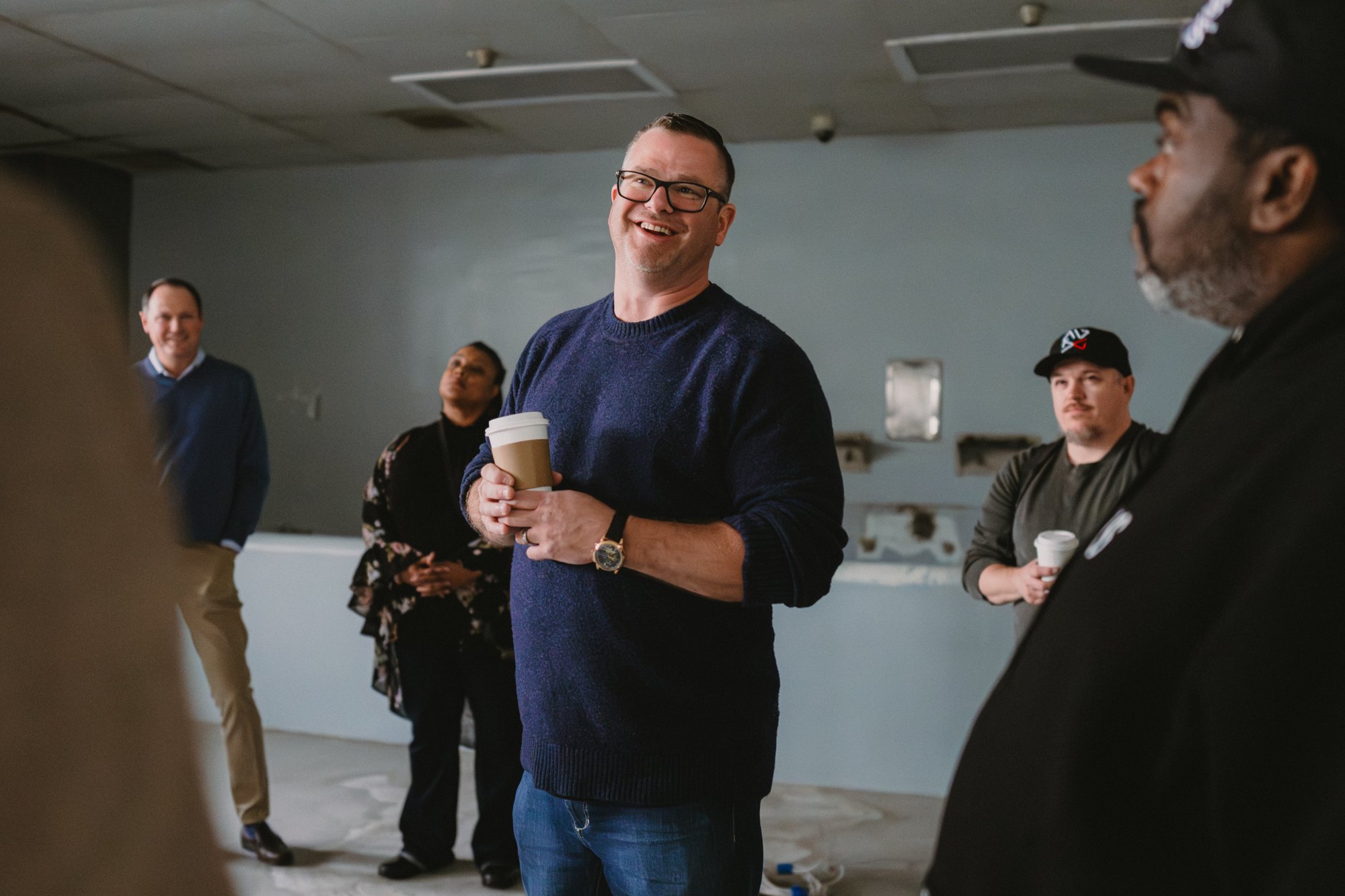 Optic8 team walking a client through the Jailhouse Studios build